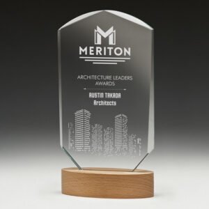 Arched clear glass corporate awards trophy with engraved building design mounted on curved timber base