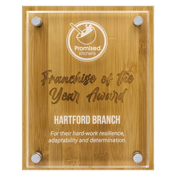 Bamboo corporate awards plaque with clear acrylic panel and engraved franchise recognition text secured with metal mounts
