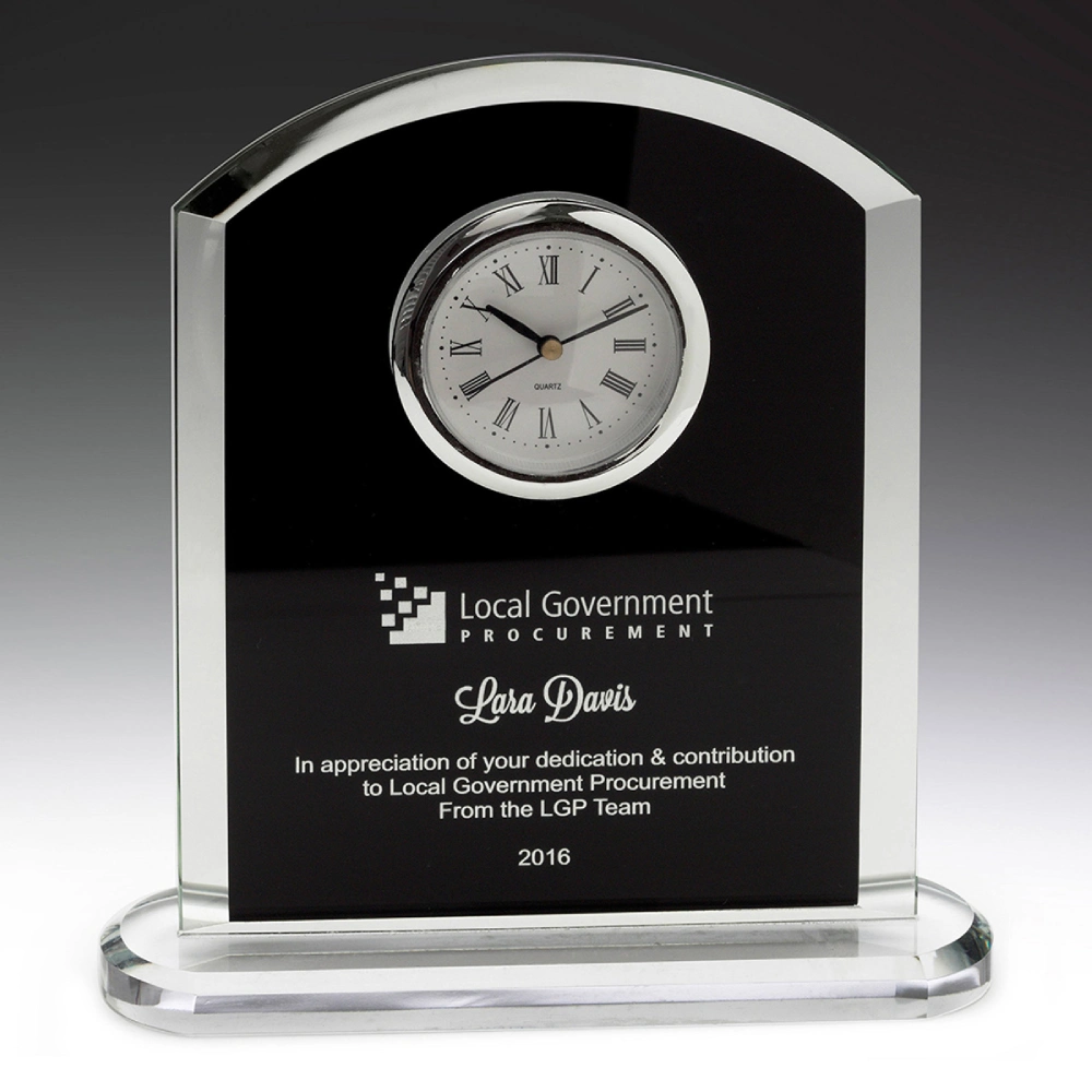 Black glass arch desk clock with roman numeral dial, clear glass edges and engraved presentation panel on a glass base