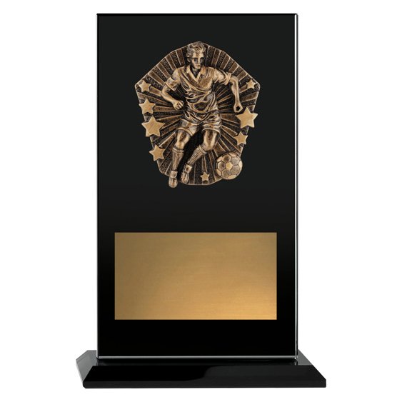 Large black glass award plaque featuring raised bronze soccer player motif with starburst detail and wide gold engraving plate, mounted on matching black base.