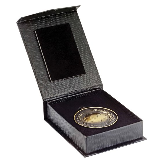 Black textured presentation case with hinged lid and velvet interior holding a round gold medal featuring a laurel wreath border and central insert space.