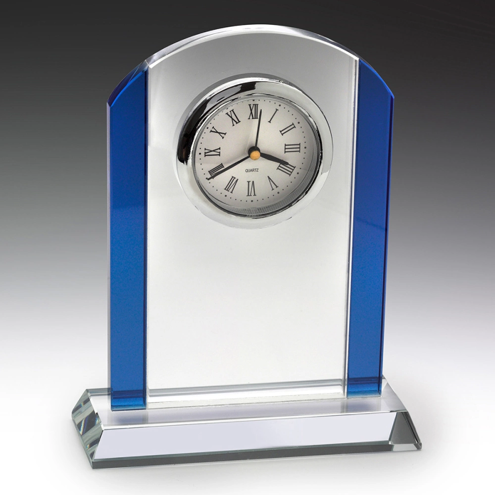 Blue glass desk clock with clear centre panel and round face with roman numerals on a glass base