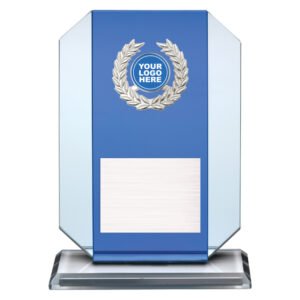 Small blue glass award plaque with silver laurel wreath emblem, round logo insert and engraved plate on clear glass base.