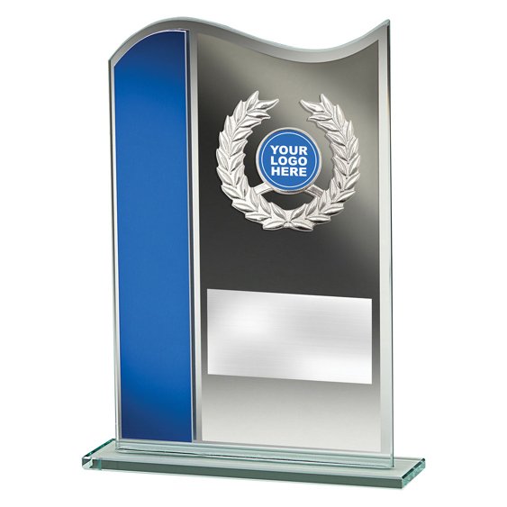 Small curved glass award plaque with blue side panel, silver laurel wreath motif, round logo insert and engraved plate on clear glass base.
