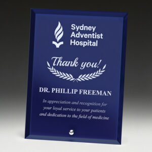 Small blue glass award plaque with silver engraving and polished bevelled edges, designed for corporate, hospital or service recognition presentations.