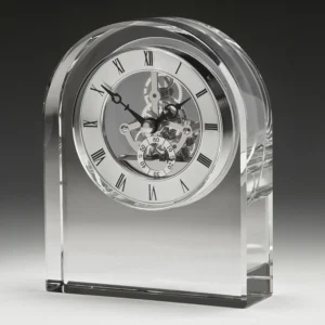 Clear crystal desk clock with arched top and skeleton dial with visible gears and roman numerals