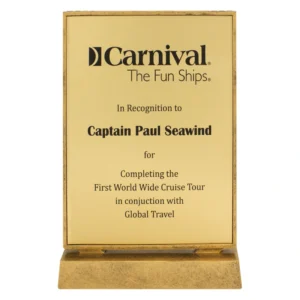 Gold engraved glass plaque award on display stand with printed recognition text