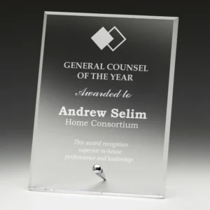 Clear glass corporate award plaque with engraved text and metal stand