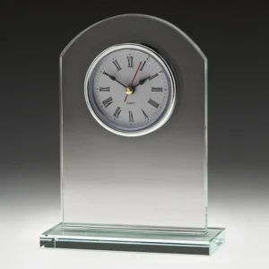 Frosted glass desk clock with arched top and round face with roman numerals on a clear base