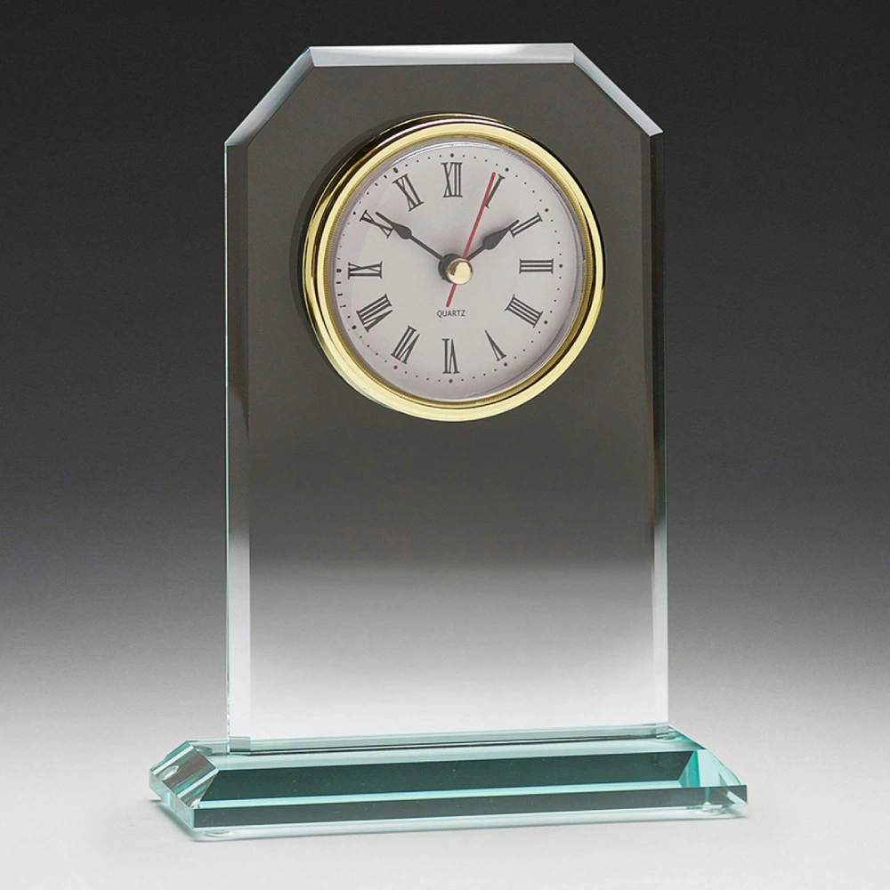Clear glass desk clock with bevelled edges and round face with roman numerals on a glass base