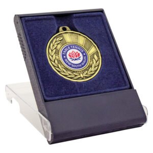 Gold medal displayed in blue velvet presentation case