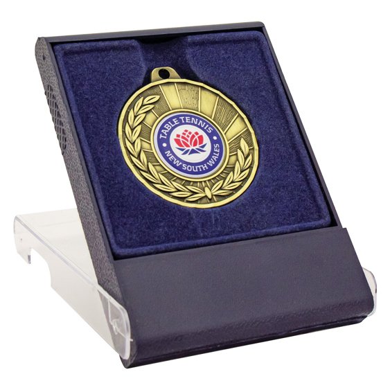 Gold medal displayed in blue velvet presentation case