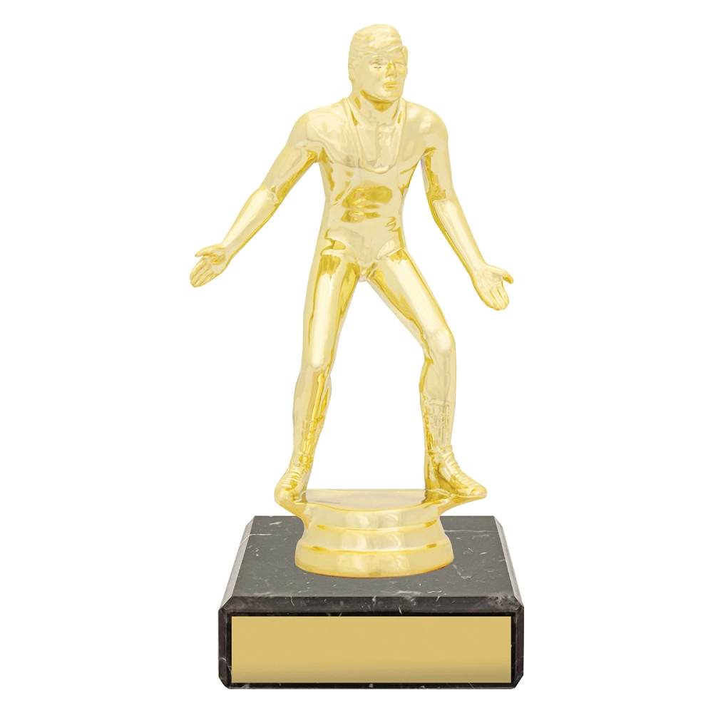Gold wrestling trophy with male wrestler figure standing with arms open on black marble base with gold engraving plate