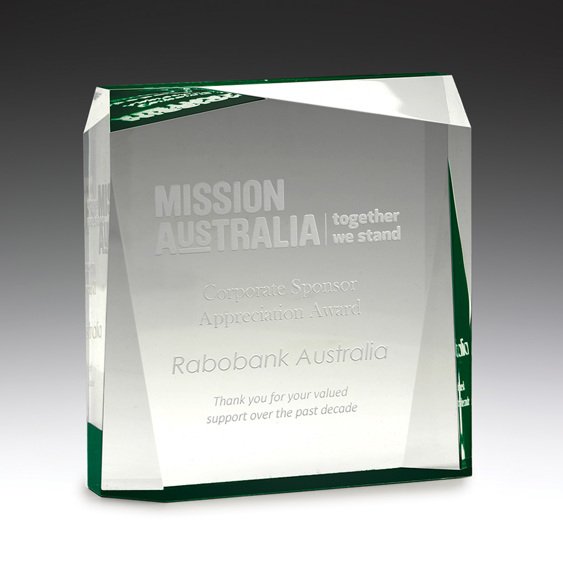 Clear glass corporate awards block with green accent edge and engraved sponsor appreciation text