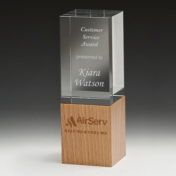 Small tall rectangular glass corporate awards trophy with engraved text mounted on natural timber block base