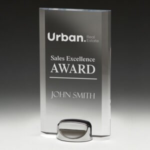 Clear rectangular glass corporate awards trophy with engraved sales excellence text on polished metal base
