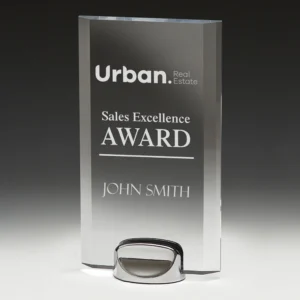 Clear rectangular glass corporate awards trophy with engraved sales excellence text on polished metal base