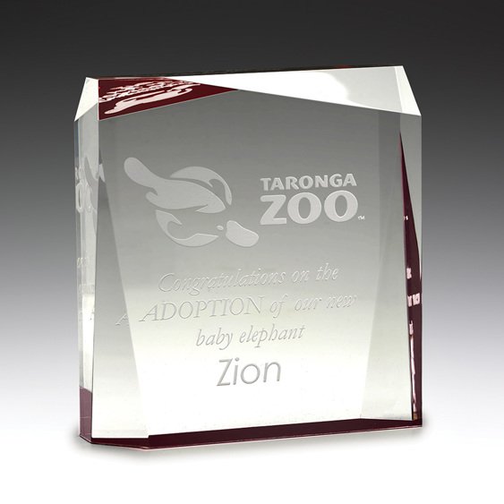 Clear glass corporate awards block with red accent edge and engraved recognition text