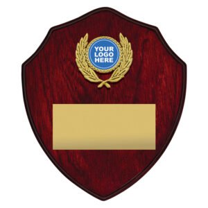 Small red wood shield plaque with gold wreath logo insert at top and large blank gold engraving plate below