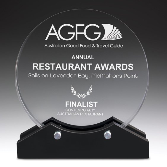 Round clear glass award with engraved restaurant awards text mounted on black base with metal supports
