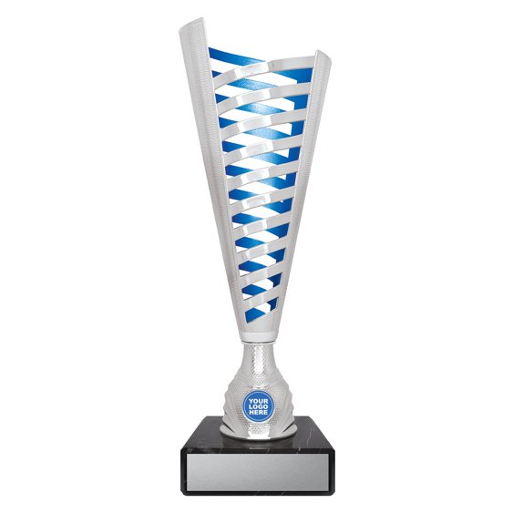 Extra large tall silver cup trophy with vertical cutout lattice design, blue inner panel detail, round logo insert holder and black marble base with engraving plate.