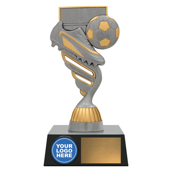 Large silver and gold soccer trophy with spiral column, boot and ball in front of goal net, circular logo insert on base, and blank gold nameplate.