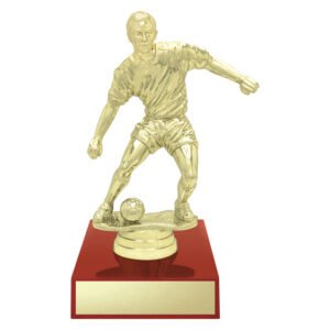 Small gold soccer player trophy figure on red base with engraving plate.