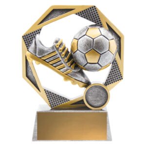 Small silver and gold soccer trophy with boot and ball inside hexagon frame on rectangular base.