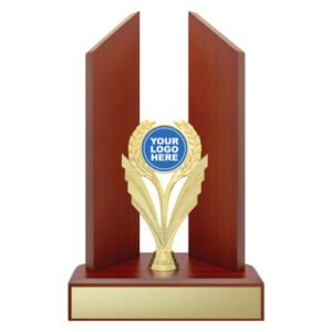Modern timber panel award with two vertical wood fins framing a central gold laurel motif and logo insert, mounted on a wide wooden base with large gold engraving plate.
