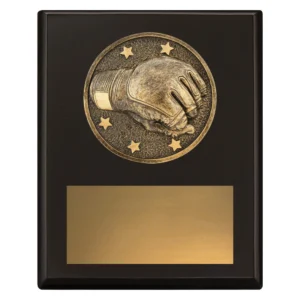 Small black wrestling award plaque with raised wrestling glove emblem and large gold engraving plate