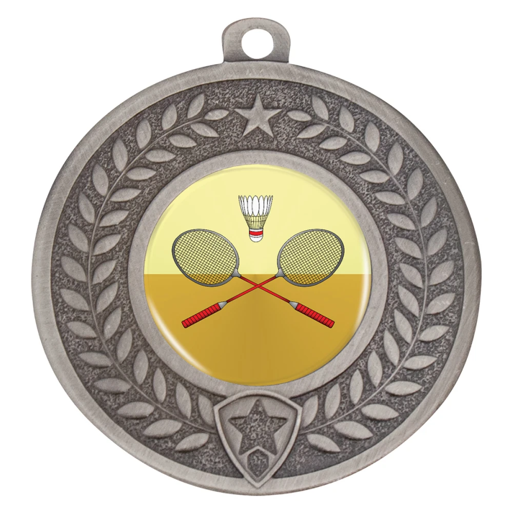 Round silver medal with raised laurel leaves and star detail around the edge. Centre insert shows crossed badminton rackets and shuttlecock. Includes top loop for ribbon attachment.