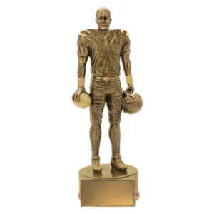 American football player figure trophy holding ball and helmet in antique gold finish on round base with engraving plate