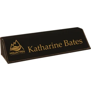 Black leather desk name plate with engraved text and stitched edges for office display