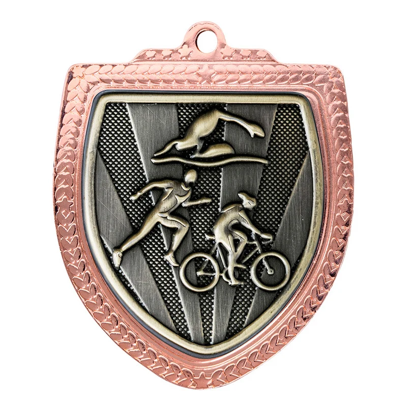 Bronze triathlon shield medal with swimmer cyclist and runner figures on textured background